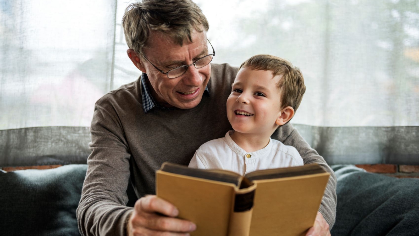 grandfather-and-grandson-reading-book-together
