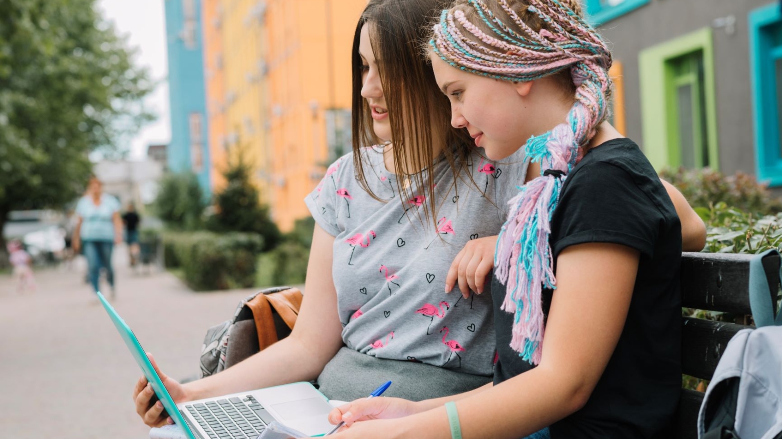 stylish-girls-studying-with-laptop-at-street